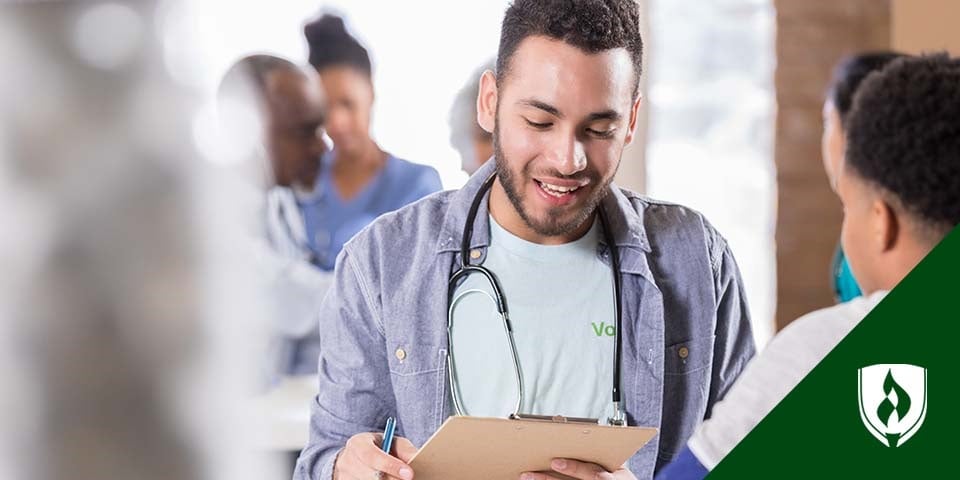photo of a student with a clipboard volunteering to get healthcare experience