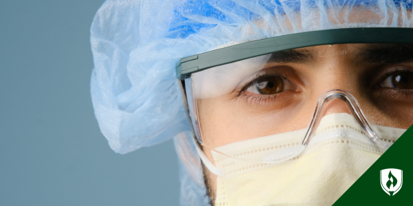 A surgical technologist in full scrub looks into the camera