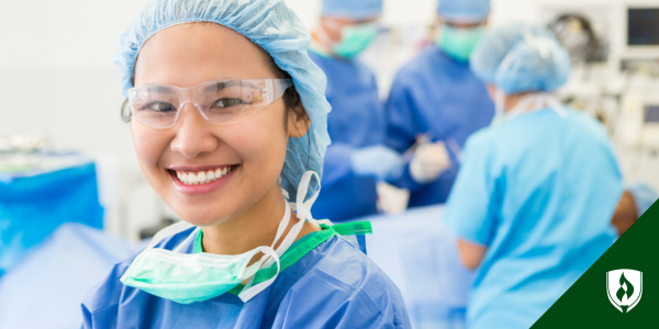 A surgical technologist smiles at the camera in scrubs