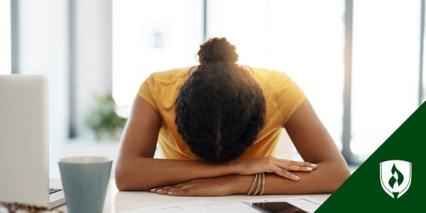 picture of a woman with her head on her desk representing i hate my job