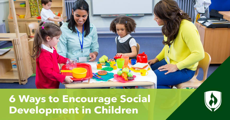 photo of two children and two teachers playing together at a table representing social development in children