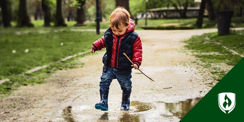 photo of a preschooler playing in the rain representing spinrg activities for preschoolers 