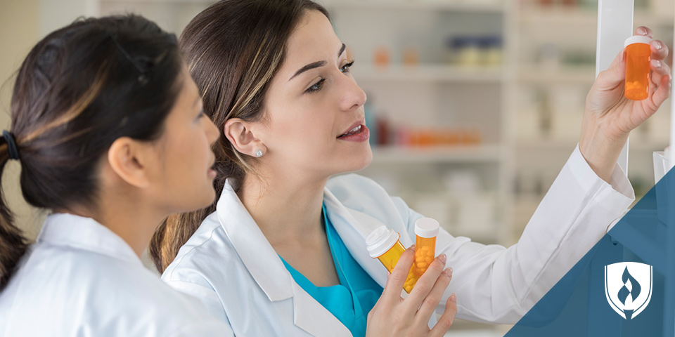 two women pharmacists looking at pills