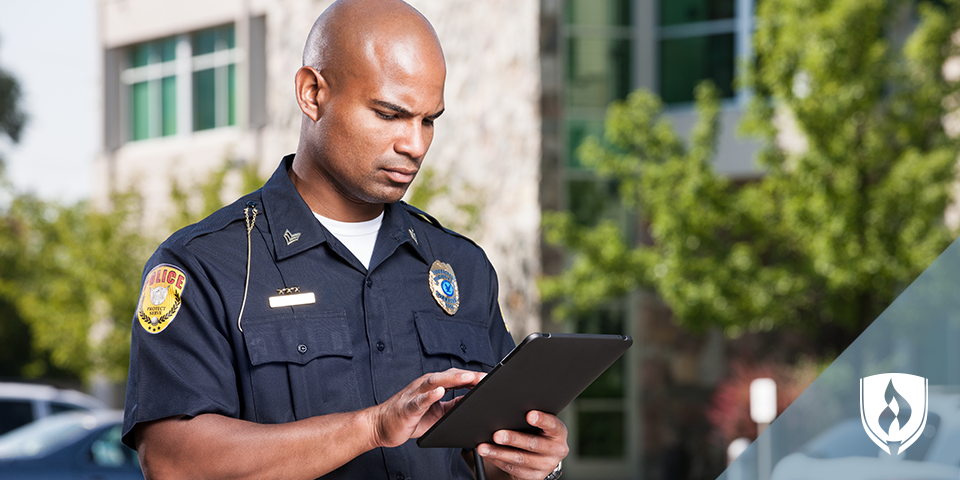 male police officer on a tablet