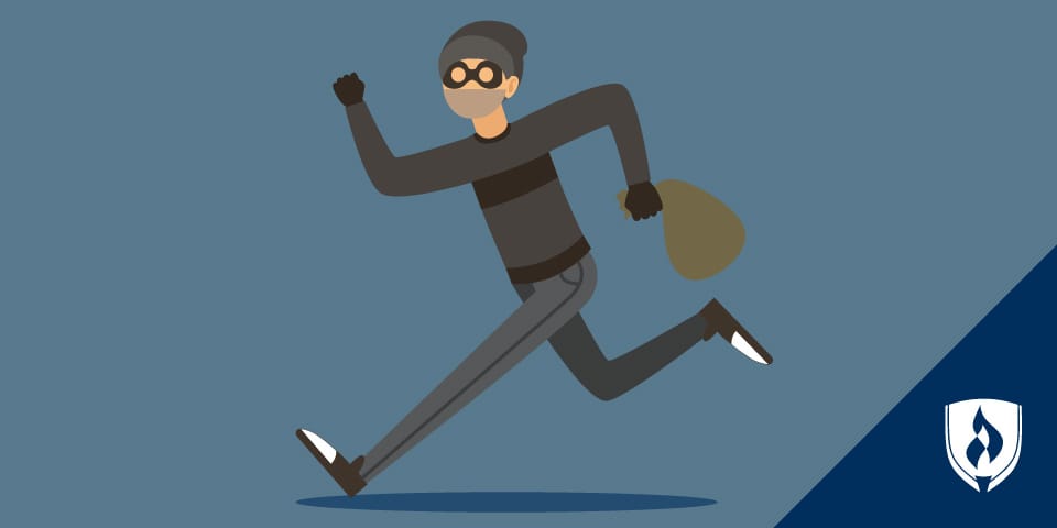 burglar wearing black mask running with bag of money fast