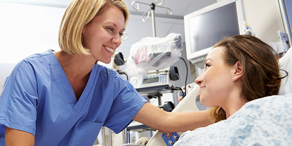 female nursing talking to female patient