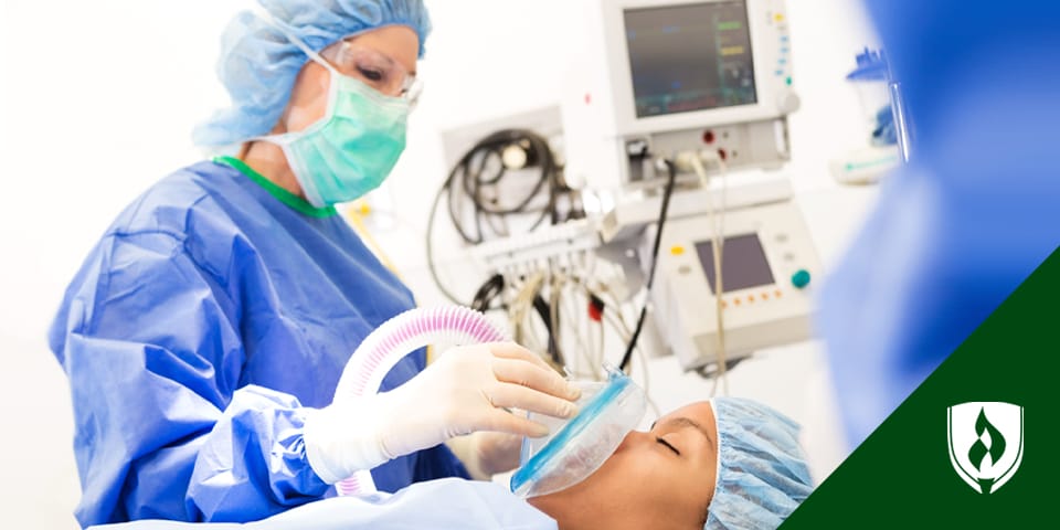 Photograph of a nurse anesthetist tending to a patient.