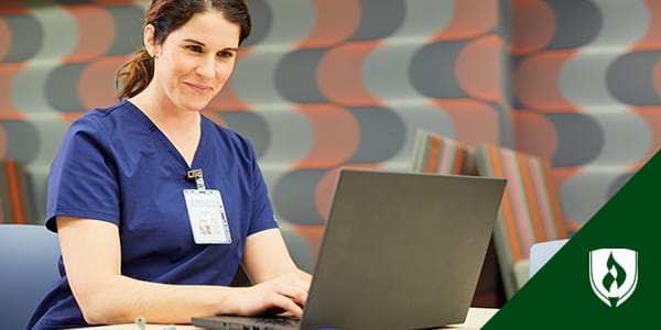 Photo of a student nurse working at a laptop.