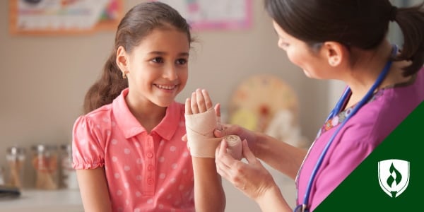 photo of a nurse wrapping a pediatric patient's wrist with an ace bandage representing pediatric nursing