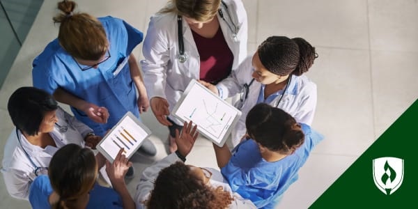 illustration of a huddle of nurses looking at charts representing clinical informatics nurse