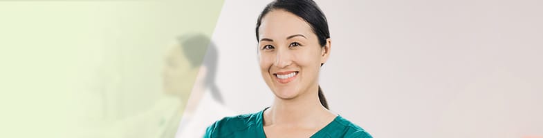 smiling female nurse with arms folded holding stethoscope 