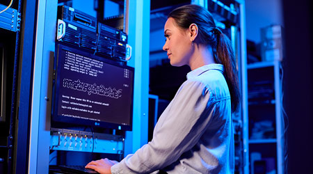 female network tech working on server