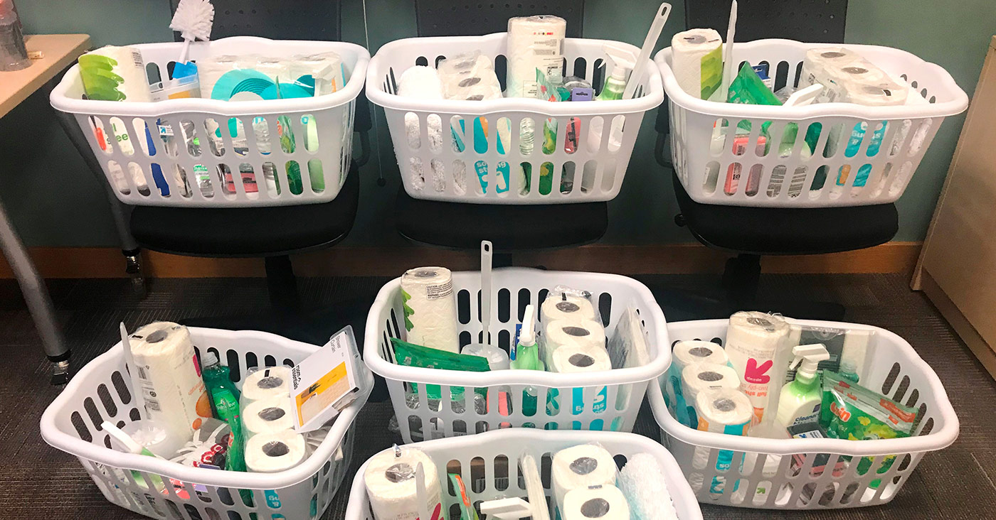 laundry baskets full of household cleaning products