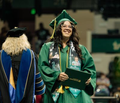 RAS_Commencement_Ceremony1_400 Rasmussen University graduate receiving diploma at commencement ceremony