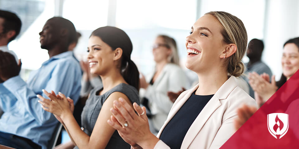 business woman sitting in conference room clapping