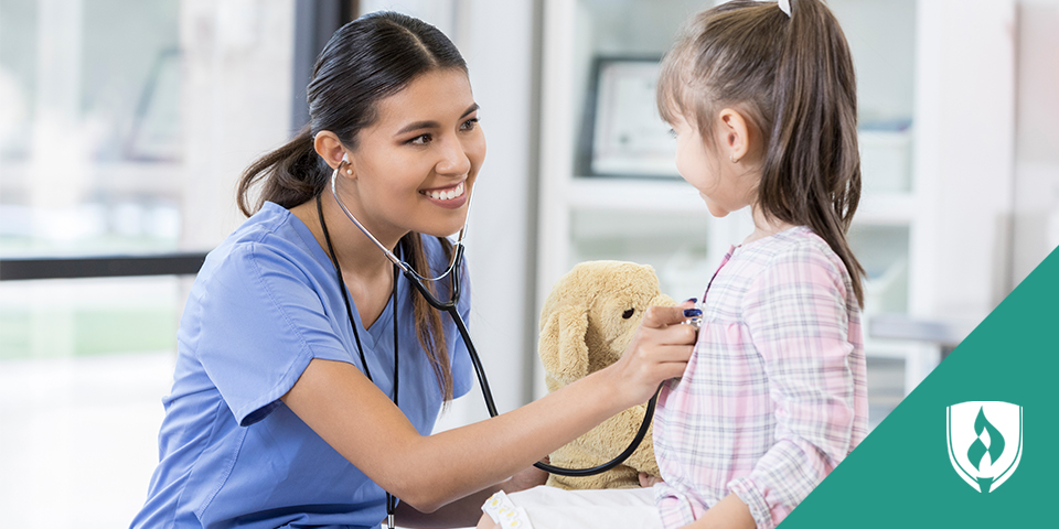 medical assistant checking child's heart rate