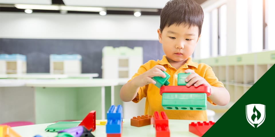 Photo of a small child playing with blocks.