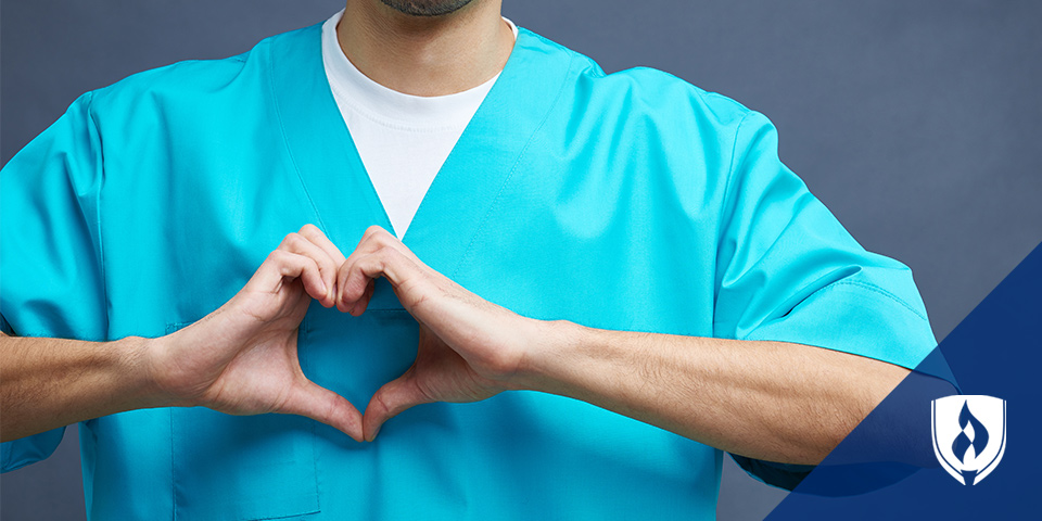 male nursing making a heart with his hands