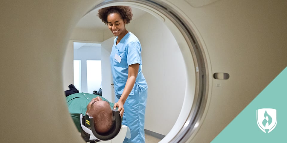 radiologic technologist assisting patient with MRI