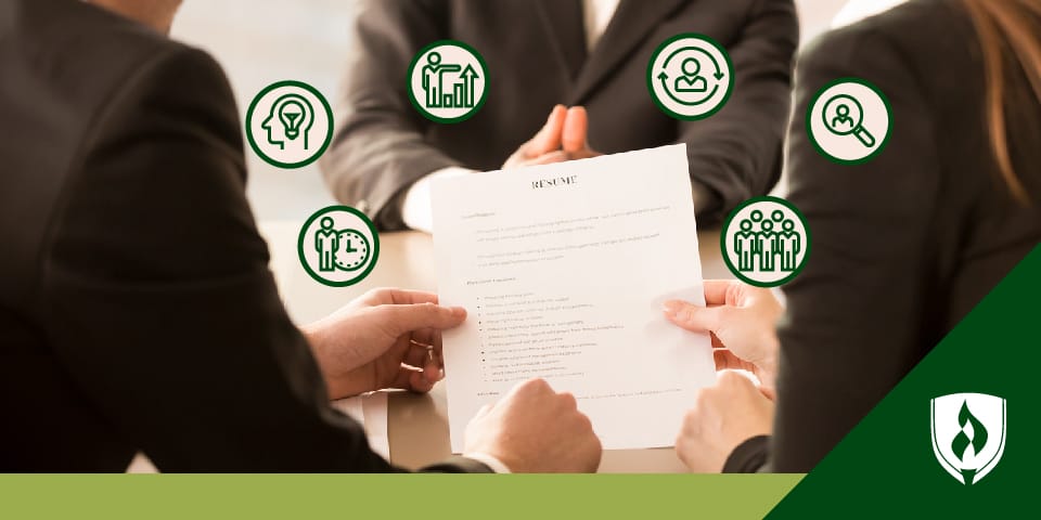 Photo of three people reviewing a resume with icons representing different skills surrounding it.