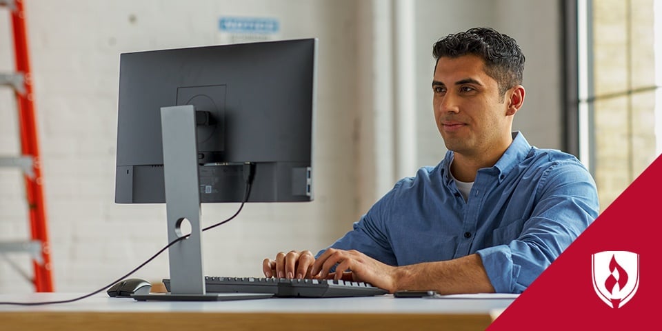 Photo of a logistics professional working at a computer
