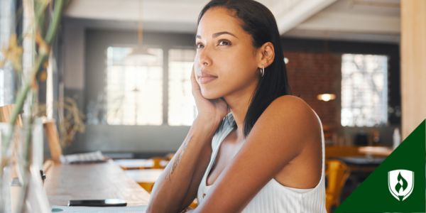 A business professional ponders by her computer