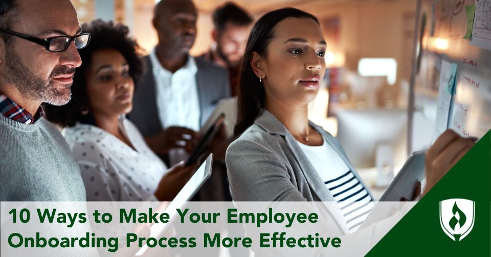 An HR specialist walks new hires through a process using a whiteboard