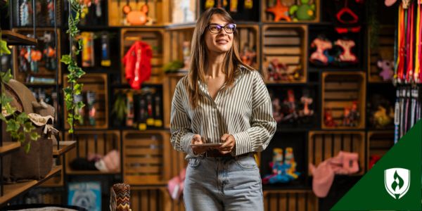 A retail manager stands in a petshop with a tablet