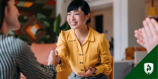A talent acquisition specialist shakes hands with a job applicant