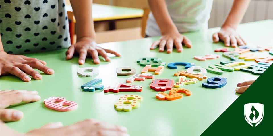 photo of preschoolers playing with letters