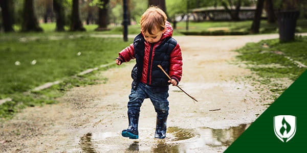 preschooler playing in the rain representing spring activities for preschoolers