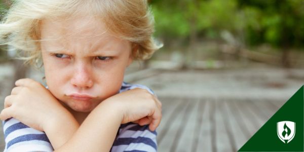 a frowning child with arms crossed