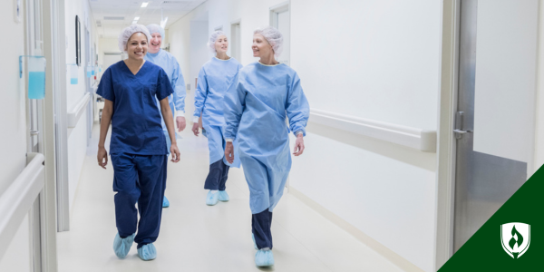 Surgical techs walk down the hall of a hospital