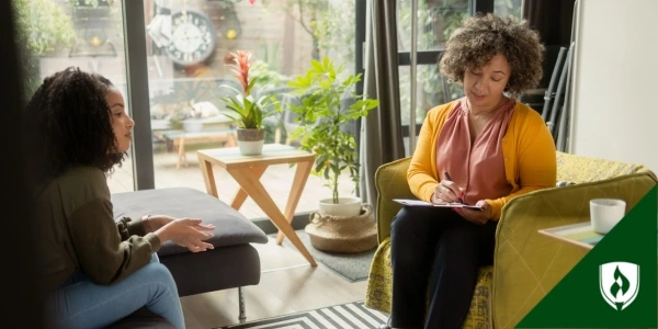 A client and behavioral health specialist meet in a bright office
