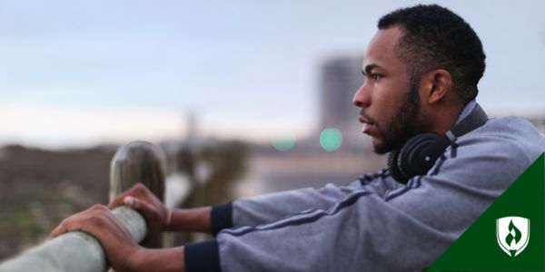 A social services assistant looks out over a field