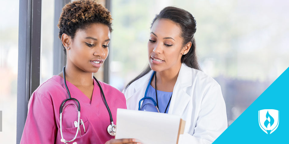 female doctor discussing a chart with female nurse