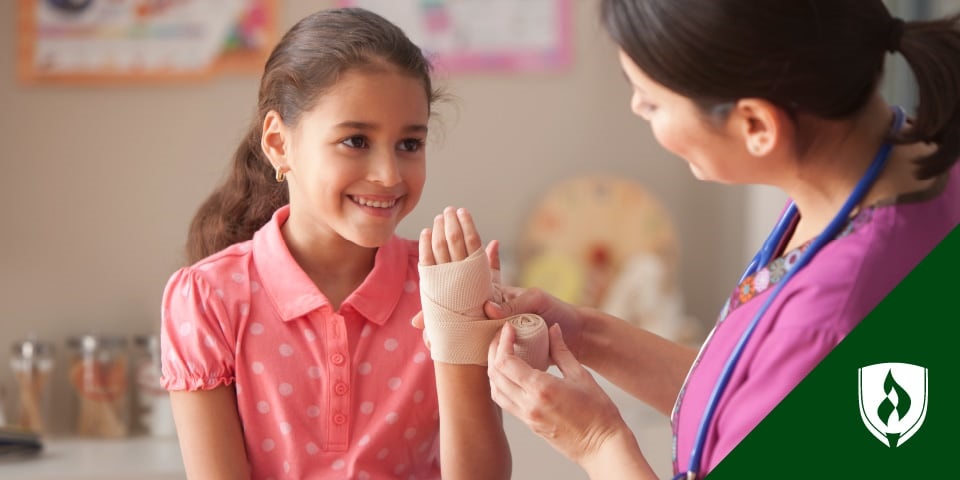 photo of a nurse wrapping a pediatric patient's wrist with an ace bandage representing pediatric nursing