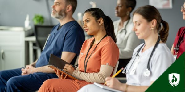Three nurses sit in a conference.
