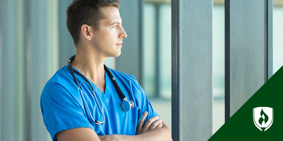 male nurse looking away with arms crossed