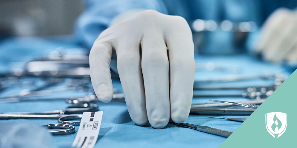 surgical tech's hand grabbing surgical tools