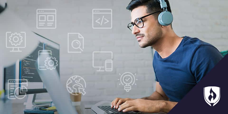 web designer with headphones working on computer