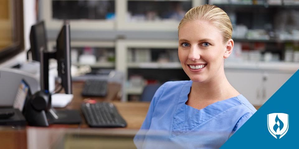 female nurse smiling at computer