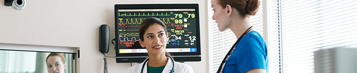 female doctor and two nurses discussing patient care