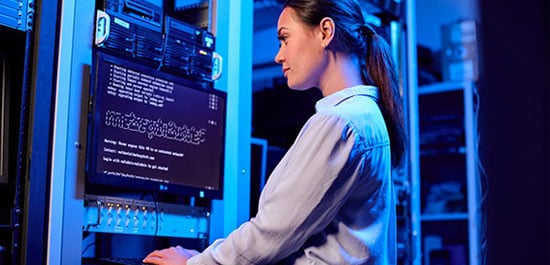 woman in front of computer screen inside server room