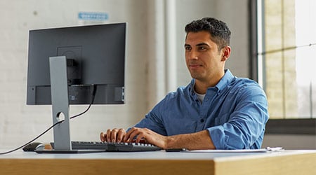 man working at desk on a computer