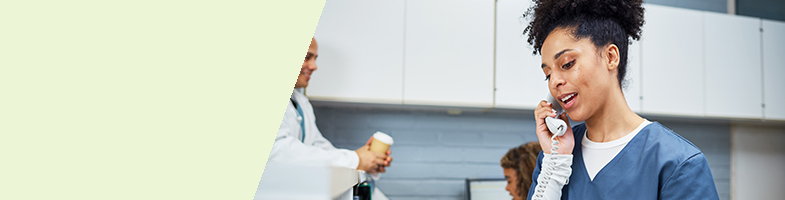 Medical administrative assistant talking on the phone in an office setting