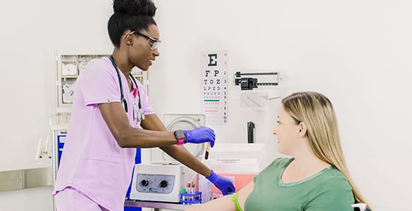 female medical assistant caring for a female patient