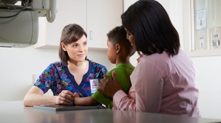 radiologic technician talking to a parent and young child