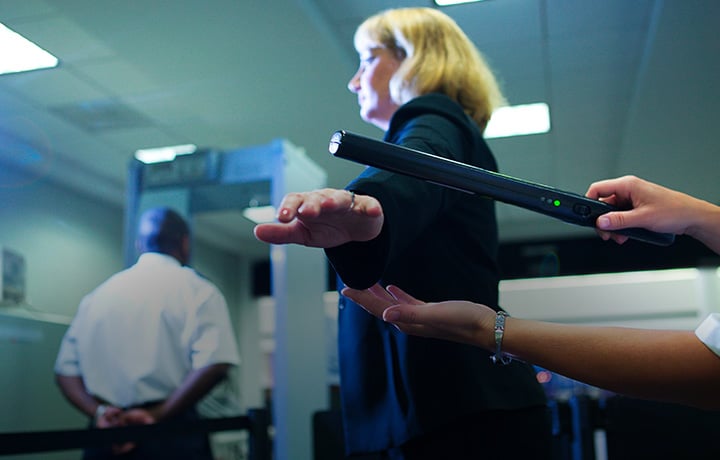 Woman being scanned at security checkpoint mobile