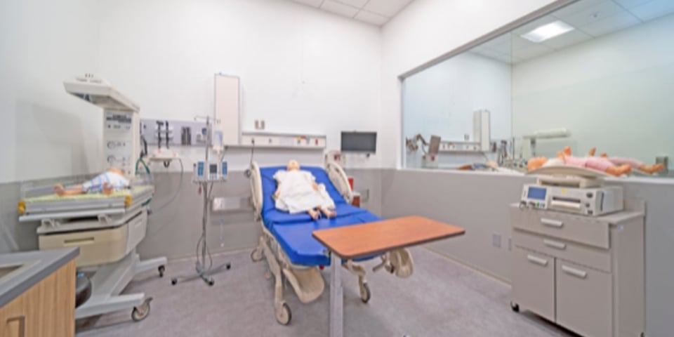 Surgical Health Sciences and Nursing lab at the Rasmussen University Central Pasco campus location with mirror for observation room.